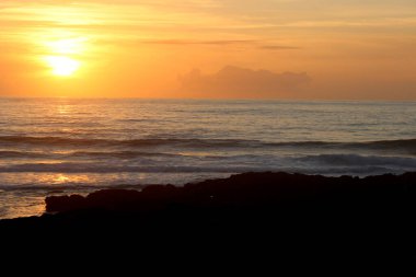 Sunset with the sun covered by the evening mist on the Atlantic Ocean, from Furnas beach. Porto do son, Coruna, Galicia