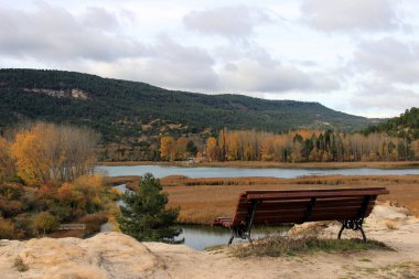 Bench to enjoy the landscape offered by the Una lagoon in the Cuenca mountains.  Castilla La Mancha. Spain