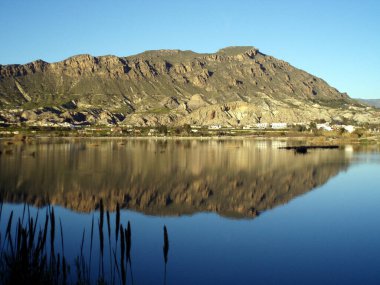 Navela and Chinte reflected in the Ojos dam, near Blanca in the Ricote valley. Blanca. Murcia. Spain