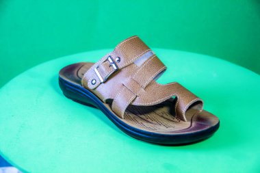 Illustrative Editorial branded photography, Slipper shouted on green Background, shot is selective focus with shallow depth of field. Photos taken at Cairo Egypt on 28 March 2019