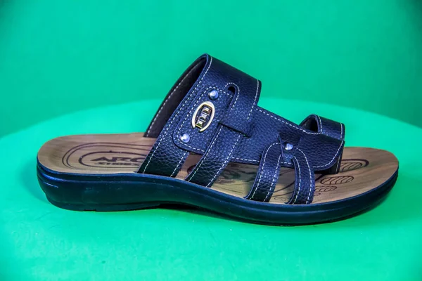 Illustrative Editorial branded photography, Slipper shouted on green Background, shot is selective focus with shallow depth of field. Photos taken at Cairo Egypt on 28 March 2019