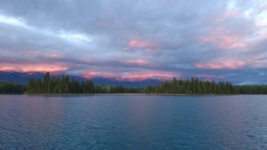 evening sky settling over lake with color in clouds
