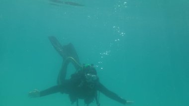 lady scuba diving in northern lake