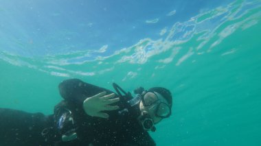 lady scuba diving in northern lake