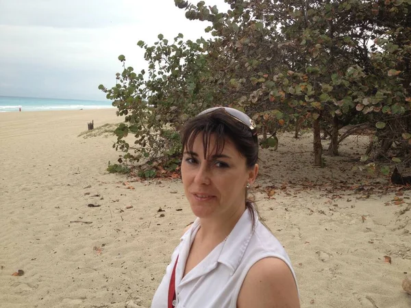beautiful woman in a white top on the beach in cuba