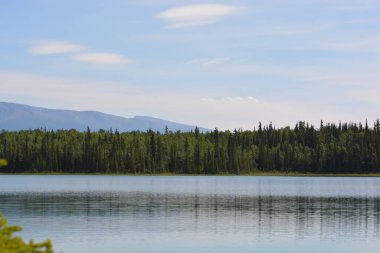 Scenic View of Boya Lake with mountains in the background