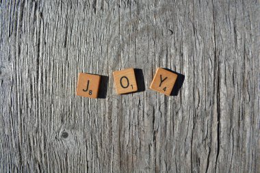 Motivational scrabble word art on old wood backing