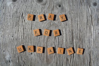 Motivational scrabble word art on old wood backing