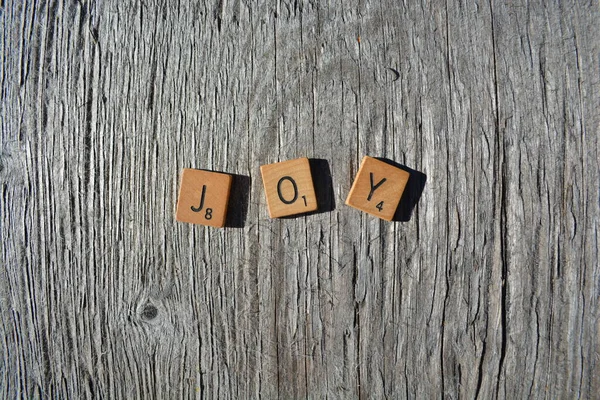 Motivational scrabble word art on old wood backing