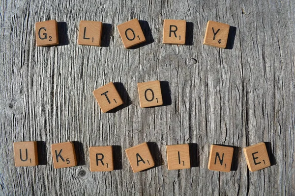 Motivational scrabble word art on old wood backing