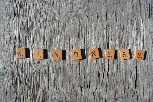 Motivational scrabble word art on old wood backing