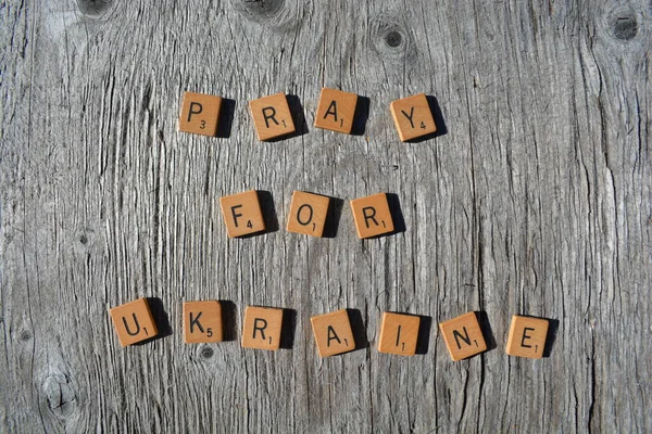 Motivational scrabble word art on old wood backing