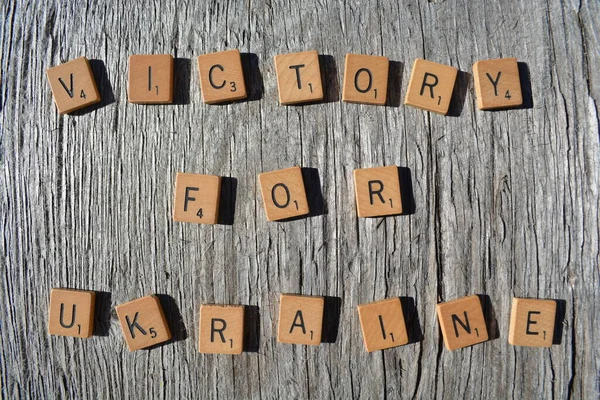 Motivational scrabble word art on old wood backing