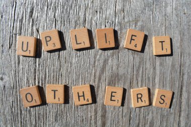 Motivational scrabble word art on old wood backing