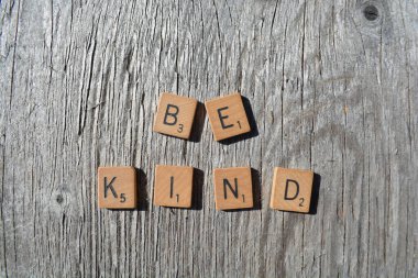 Motivational scrabble word art on old wood backing