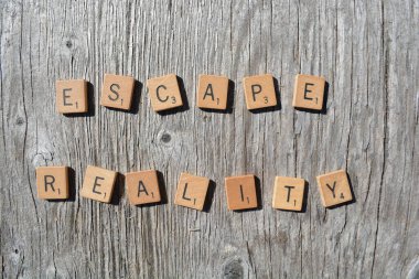 Motivational scrabble word art on old wood backing