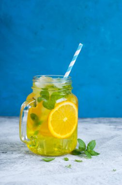 ice orange mojito style beverage on blue background
