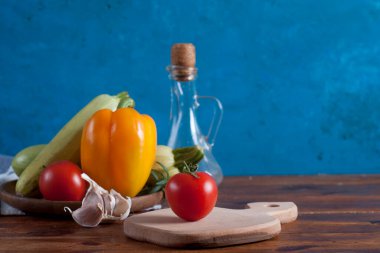 fresh ripe tomatoes and olive oil in a rustic kitchen. copy space