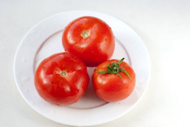raw tomato on White plate