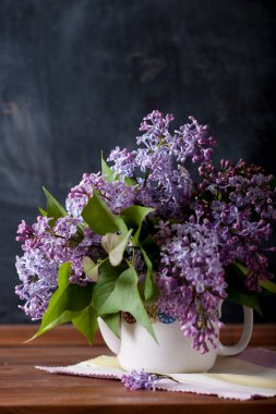 lilac in vase on dark background