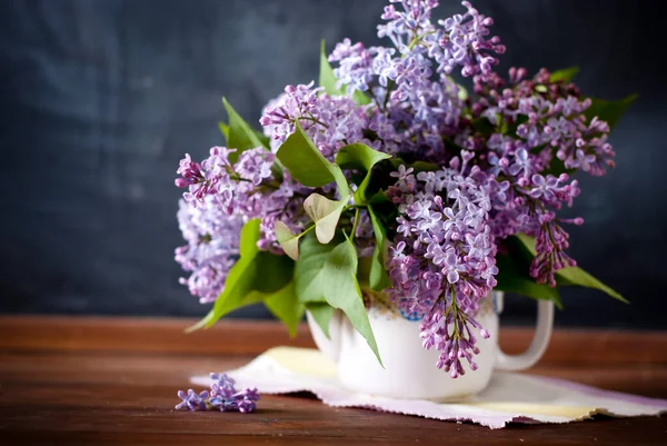 lilac in vase on dark background