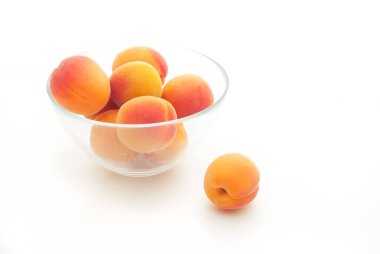apricots in a cup on white background