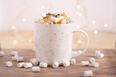 coffee with whipped cream, marshmallow and caramel topping