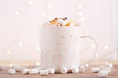coffee with whipped cream, marshmallow and caramel topping