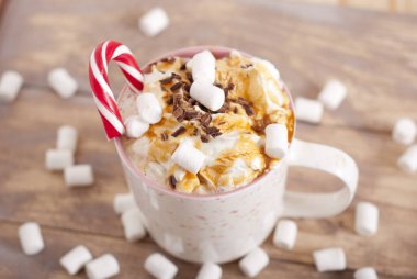 coffee with whipped cream, marshmallow and coffee beans