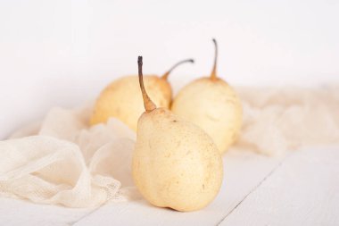 chinese pears on white wooden table