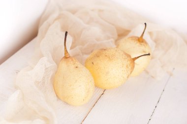 chinese pears on white wooden table