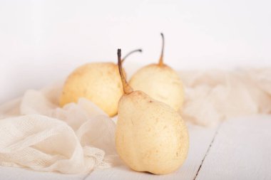 chinese pears on white wooden table