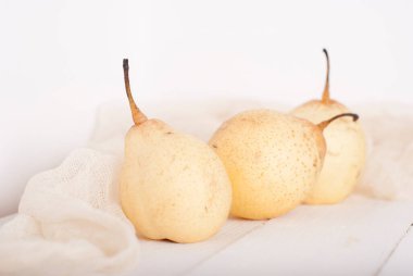 chinese pears on white wooden table