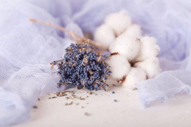 lavender and cotton with violet textile on white wooden table. 
