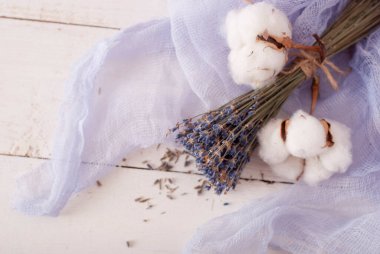 lavender and cotton with violet textile on white wooden table. 