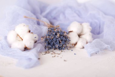 lavender and cotton with violet textile on white wooden table. 