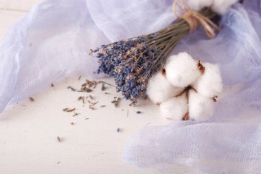 lavender and cotton with violet textile on white wooden table. 