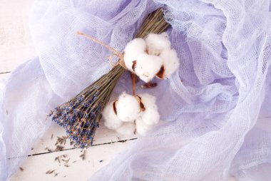 lavender and cotton with violet textile on white wooden table. 