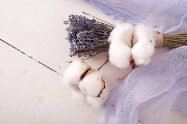 lavender and cotton with violet textile on white wooden table. 
