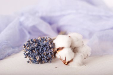 lavender and cotton with violet textile on white wooden table. 