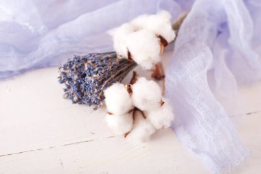 lavender and cotton with violet textile on white wooden table. 