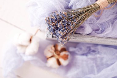 lavender and cotton with violet textile on white wooden table. 