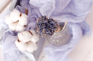 lavender and cotton with violet textile on white wooden table. 