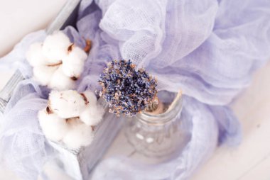 lavender and cotton with violet textile on white wooden table. 