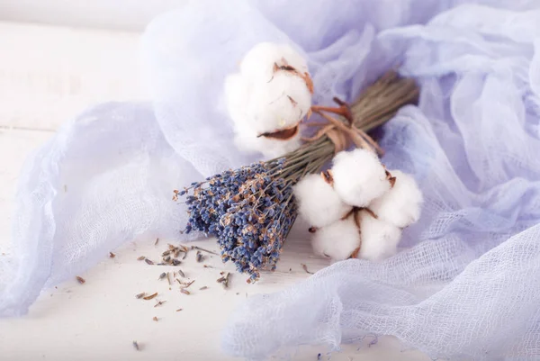 lavender and cotton with violet textile on white wooden table. 