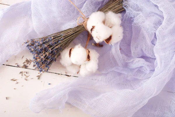 lavender and cotton with violet textile on white wooden table. 