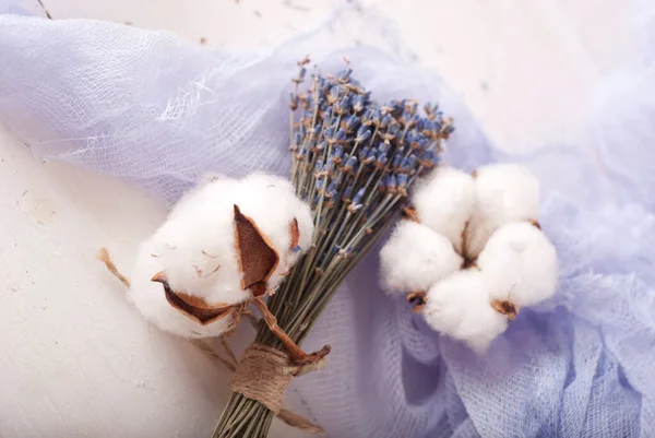 lavender and cotton with violet textile on white wooden table. 