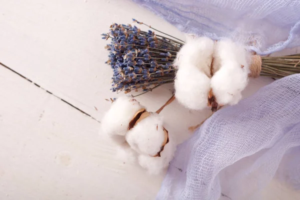 lavender and cotton with violet textile on white wooden table. 