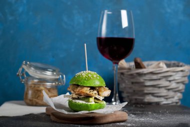 green home made burger on dark blue background
