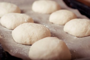 raw homemade hamburger rolls ready to be baked